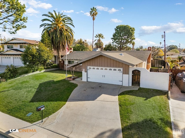 ranch-style house with an attached garage, board and batten siding, a fenced front yard, a front yard, and driveway