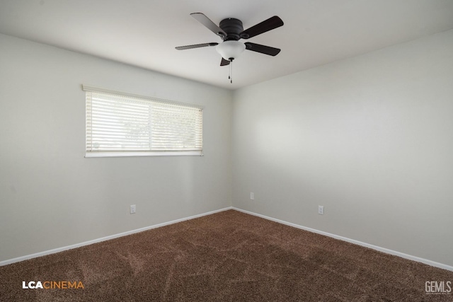 carpeted spare room with baseboards and a ceiling fan