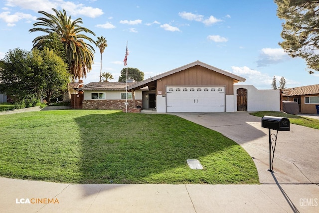 view of front of home featuring a front yard, an attached garage, and concrete driveway