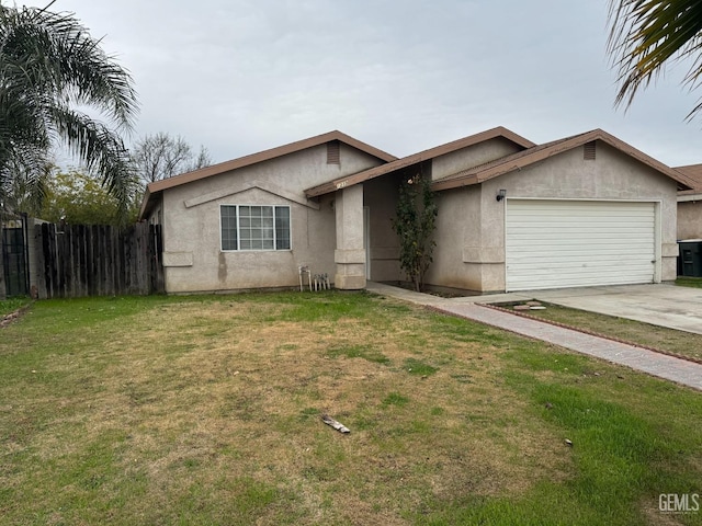 single story home featuring a garage and a front lawn