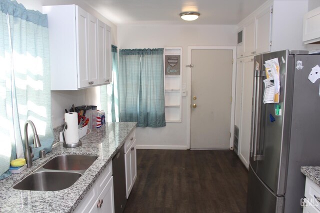 327 Ray St, Bakersfield, CA 93308 - kitchen featuring appliances with stainless steel finishes, dark wood finished floors, white cabinets, and light stone counters