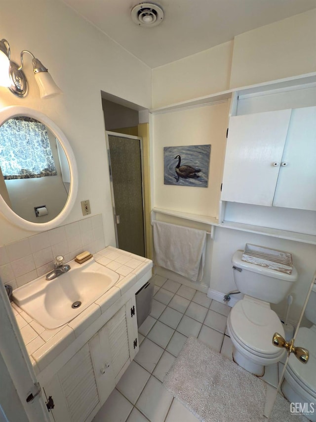 bathroom featuring tile patterned floors, toilet, visible vents, backsplash, and a shower stall