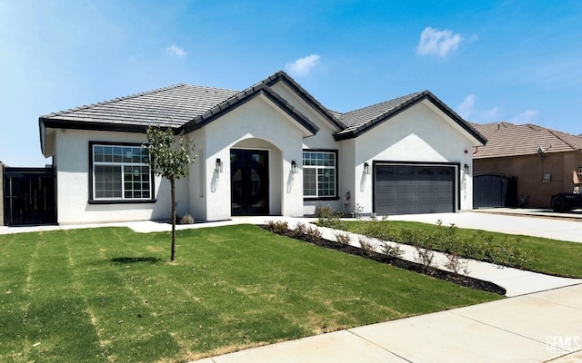 view of front of home featuring a garage and a front lawn