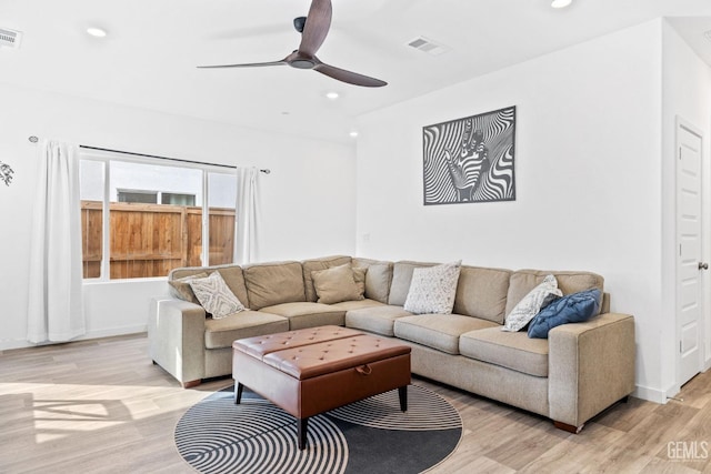 living room featuring ceiling fan and light hardwood / wood-style flooring