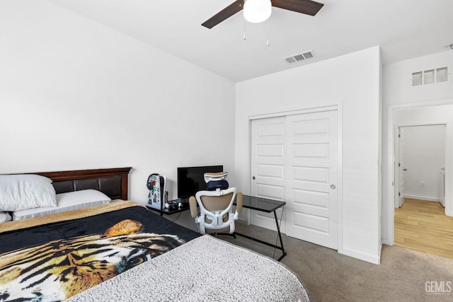 carpeted bedroom featuring a closet and ceiling fan