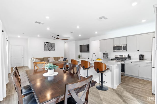 dining room featuring ceiling fan and light hardwood / wood-style flooring