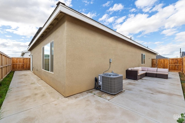 view of property exterior with cooling unit, outdoor lounge area, and a patio