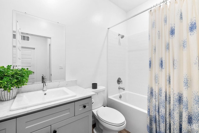 full bathroom featuring vanity, shower / bath combination with curtain, and toilet