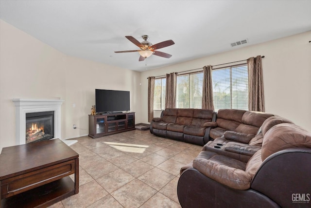 living room featuring ceiling fan and light tile patterned flooring