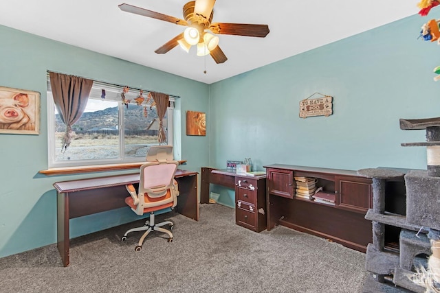 carpeted home office with ceiling fan and a mountain view