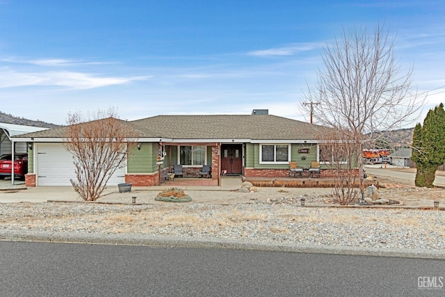 ranch-style house featuring a garage, a porch, and a carport