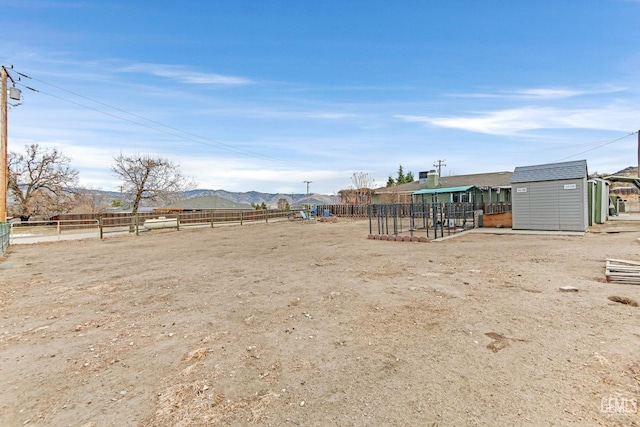 view of yard with a mountain view and a storage unit