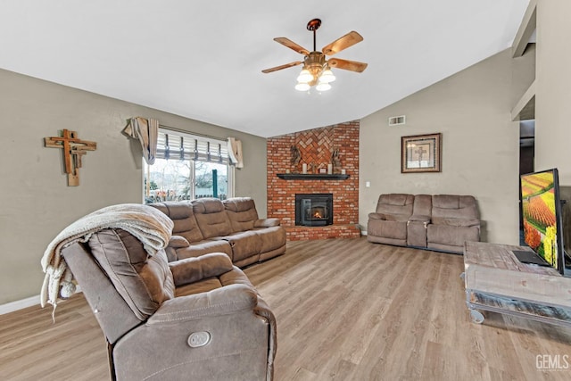 living room with light wood-type flooring, ceiling fan, and lofted ceiling