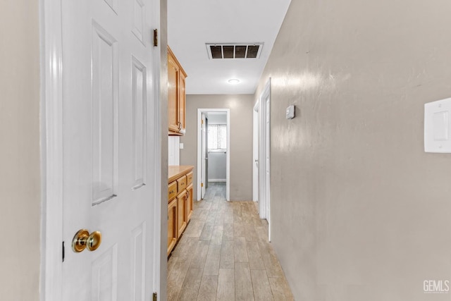 hall with light hardwood / wood-style floors