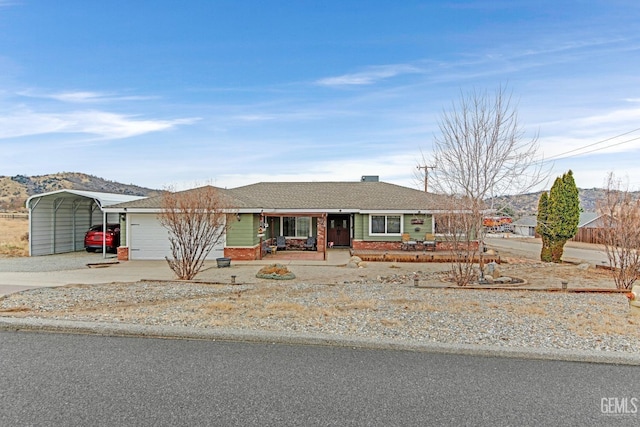 ranch-style house with a carport, a garage, and covered porch