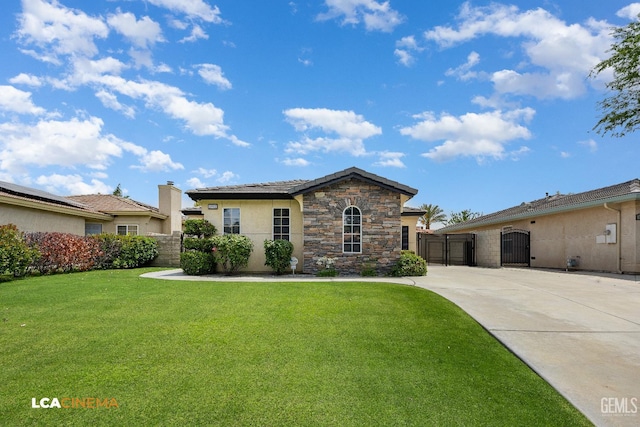 5502 White Pine Way, Bakersfield, CA 93313 - view of front of property featuring a gate, a front yard, stone siding, and stucco siding
