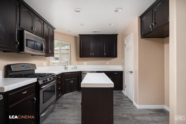 5502 White Pine Way, Bakersfield, CA 93313 - kitchen featuring appliances with stainless steel finishes, tile countertops, wood finished floors, recessed lighting, and baseboards