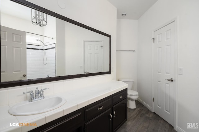 5502 White Pine Way, Bakersfield, CA 93313 - full bathroom featuring toilet, wood finished floors, vanity, a shower, and baseboards