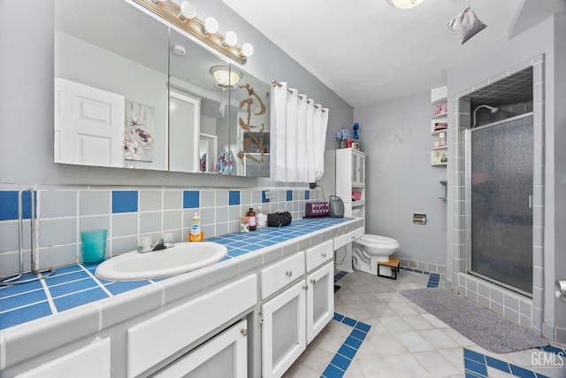 full bathroom with toilet, tile patterned floors, vanity, a shower stall, and backsplash