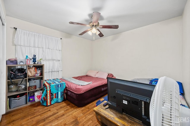 bedroom featuring a ceiling fan and wood finished floors