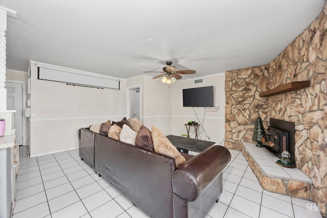 living room featuring a ceiling fan and light tile patterned floors