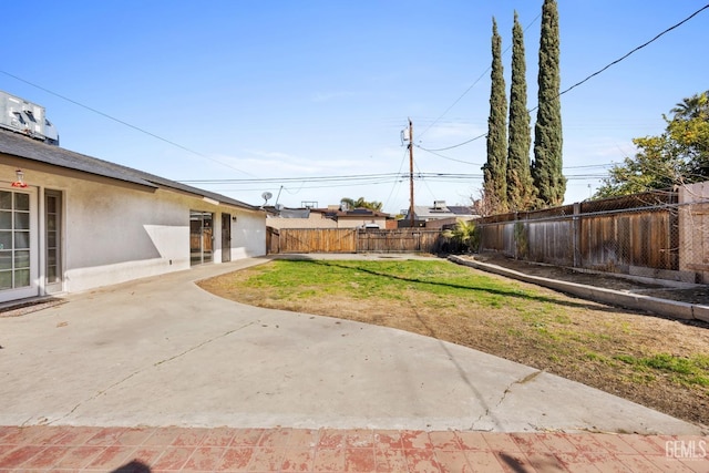 view of yard with a patio area and a fenced backyard