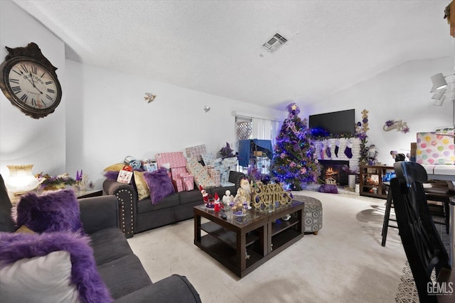 6009 Cedar Glen Ln, Bakersfield, CA 93313 - carpeted living room featuring vaulted ceiling, a lit fireplace, and a textured ceiling