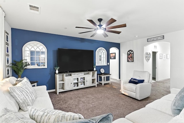 8907 Stevie Ct, Bakersfield, CA 93313 - carpeted living area with arched walkways and a ceiling fan