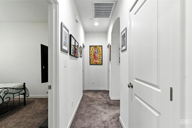 8907 Stevie Ct, Bakersfield, CA 93313 - hallway featuring dark carpet and baseboards