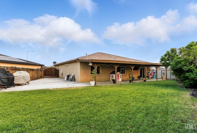 8907 Stevie Ct, Bakersfield, CA 93313 - back of property featuring a patio area, a gate, stucco siding, and a shed