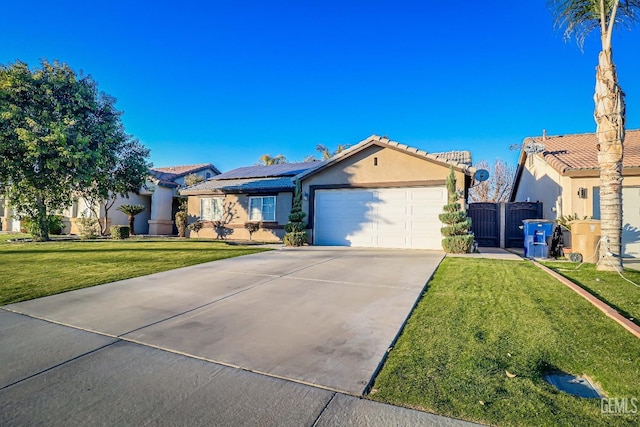 view of front of property with solar panels, a front lawn, and a garage