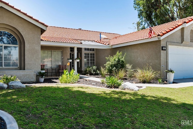 812 Mazatlan Dr, Bakersfield, CA 93314 - entrance to property with an attached garage, stucco siding, a yard, and a tile roof