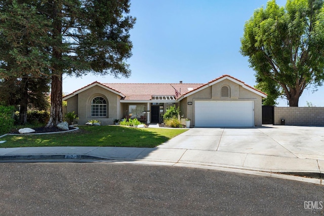 812 Mazatlan Dr, Bakersfield, CA 93314 - view of front of property featuring a tiled roof, stucco siding, an attached garage, and concrete driveway