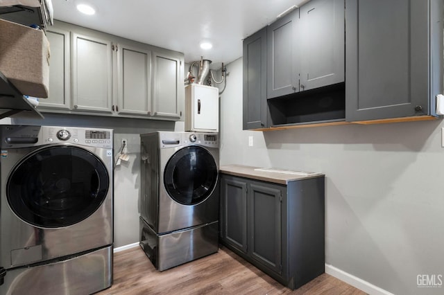 812 Mazatlan Dr, Bakersfield, CA 93314 - laundry area featuring washing machine and clothes dryer, cabinet space, light wood-style floors, and recessed lighting