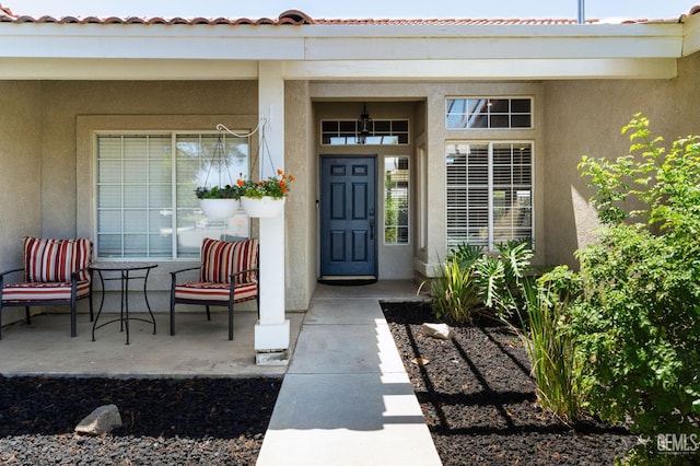 812 Mazatlan Dr, Bakersfield, CA 93314 - entrance to property featuring stucco siding, a porch, and a tile roof