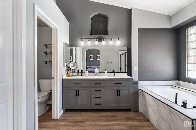 812 Mazatlan Dr, Bakersfield, CA 93314 - full bathroom featuring a garden tub, healthy amount of natural light, double vanity, and wood finished floors