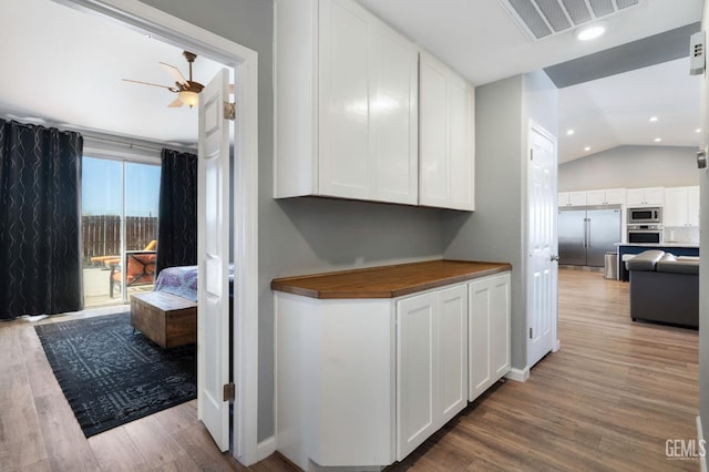 812 Mazatlan Dr, Bakersfield, CA 93314 - kitchen featuring built in appliances, butcher block counters, a ceiling fan, light wood finished floors, and vaulted ceiling