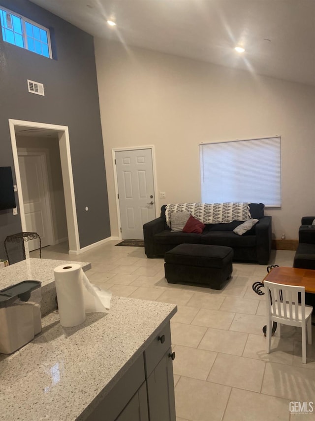 tiled living room with a high ceiling