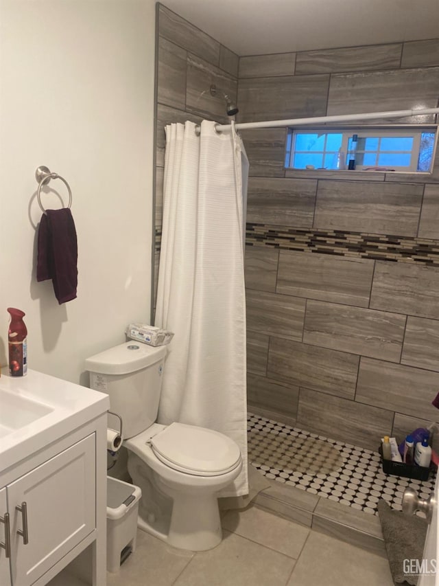 bathroom with a shower with curtain, tile patterned flooring, vanity, and toilet