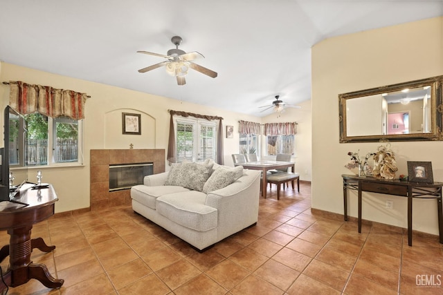 5601 Sugar Pine Dr, Bakersfield, CA 93313 - living room with a ceiling fan, light tile patterned flooring, a tile fireplace, and vaulted ceiling