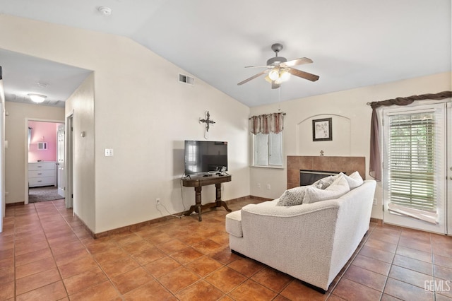5601 Sugar Pine Dr, Bakersfield, CA 93313 - living area featuring vaulted ceiling, a ceiling fan, light tile patterned floors, and a fireplace