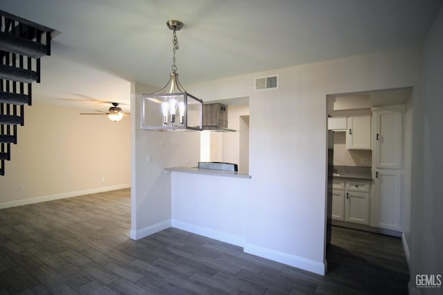 4801 Belle Ter Unit C, Bakersfield, CA 93309 - kitchen featuring wall chimney exhaust hood, dark wood-style floors, ceiling fan, pendant lighting, and white cabinets