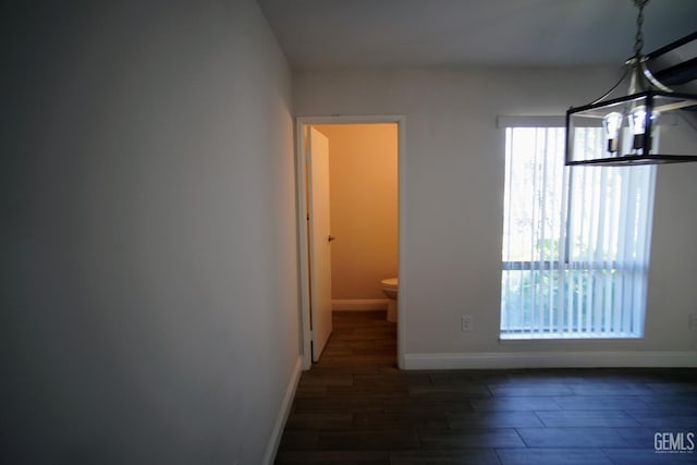 4801 Belle Ter Unit C, Bakersfield, CA 93309 - unfurnished dining area featuring baseboards and wood finished floors