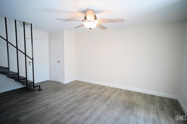 4801 Belle Ter Unit C, Bakersfield, CA 93309 - unfurnished room featuring wood finished floors, ceiling fan, and stairs