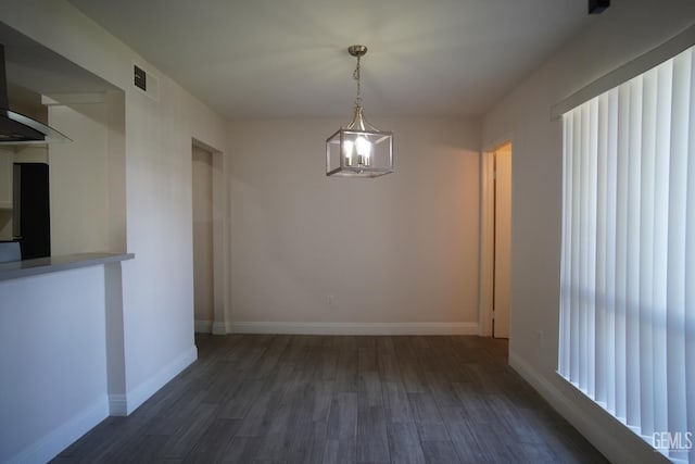 4801 Belle Ter Unit C, Bakersfield, CA 93309 - unfurnished dining area featuring dark wood finished floors and baseboards