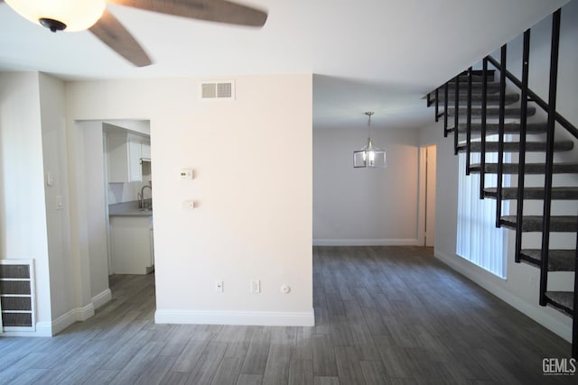 4801 Belle Ter Unit C, Bakersfield, CA 93309 - unfurnished living room featuring ceiling fan, dark wood-type flooring, and stairs