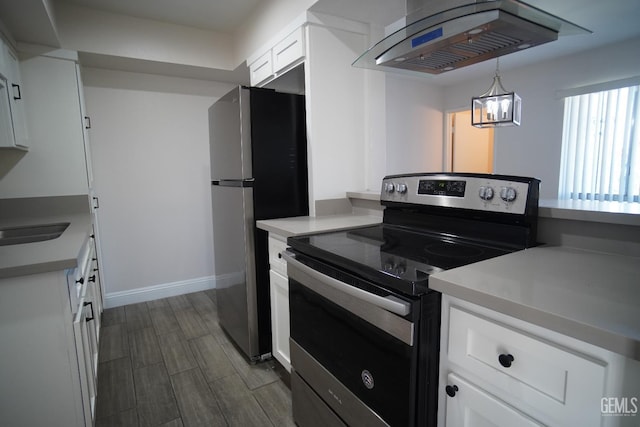 4801 Belle Ter Unit C, Bakersfield, CA 93309 - kitchen with appliances with stainless steel finishes, extractor fan, white cabinetry, light countertops, and dark wood-style floors