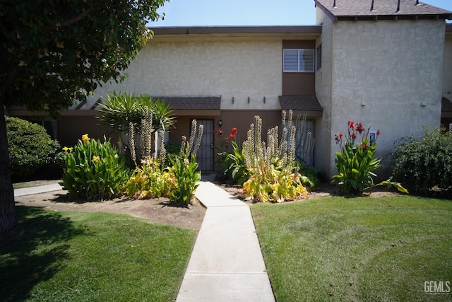 4801 Belle Ter Unit C, Bakersfield, CA 93309 - view of front of house featuring a front yard, stucco siding, and a shingled roof