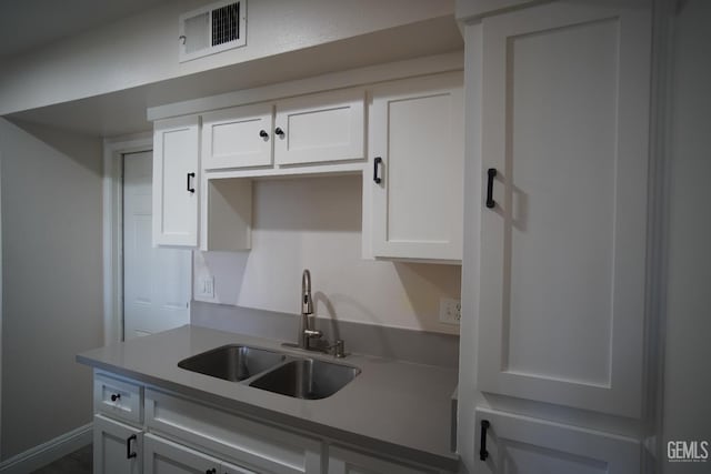 4801 Belle Ter Unit C, Bakersfield, CA 93309 - kitchen featuring a sink and white cabinets