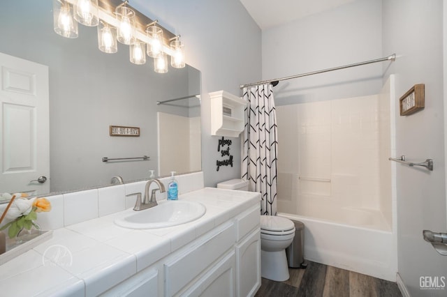 full bathroom featuring vanity, toilet, wood-type flooring, and shower / tub combo